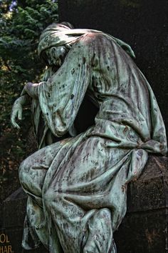 a statue of a man with his head in his hands