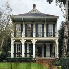 a large white house with black shutters on the front