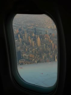 an airplane window looking out at the city