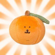 an orange with a face drawn on it