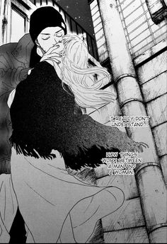 an image of a man kissing a woman on the cheek in front of a building