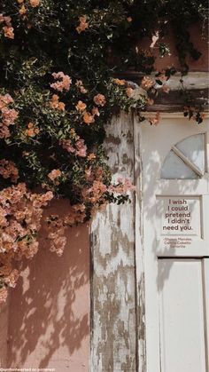 an old door with pink flowers growing over it