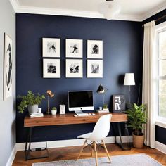 a home office with blue walls and pictures on the wall