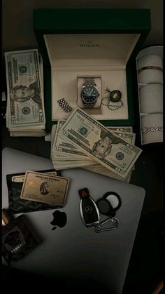 an apple computer with money, scissors and other items