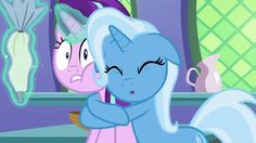 two little ponys standing next to each other in front of a mirror with their eyes closed