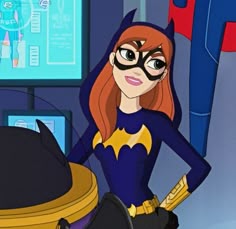 the animated batgirl is standing next to a desk