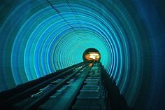 a train traveling through a tunnel filled with blue lights