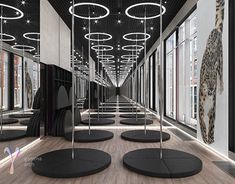 an empty room with black and white decorations on the ceiling, suspended by circular lights