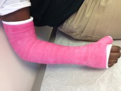 a person with pink cast on their leg