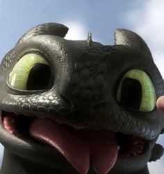 a close up of a toothless dragon with its mouth open and eyes wide open