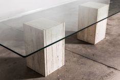 a glass table with two marble blocks on it