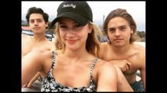 two men and a woman posing for the camera