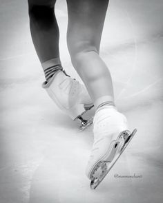 the legs and feet of a person wearing ice skates