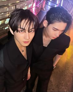 two young men standing next to each other