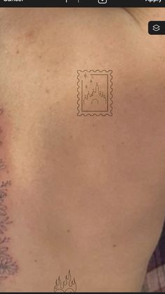 the back of a man with tattoos on his chest