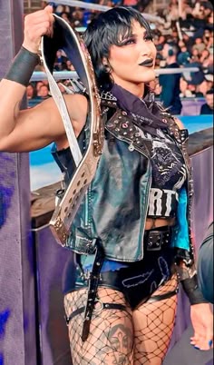 a woman in fishnet stockings and leather jacket