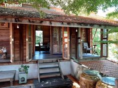 an old wooden house with steps leading up to the front door and covered porch area