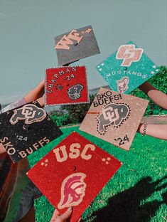 a group of people holding up some very cute looking patches in the air with words on them