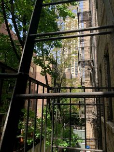 the view from inside an apartment building looking up at trees