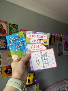 a person holding up some cards in their hand with the words, peace tober and zine on them
