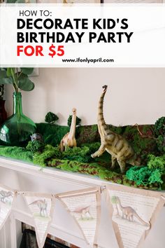 a dinosaur birthday party with fake dinosaurs on the mantel and banner for $ 5