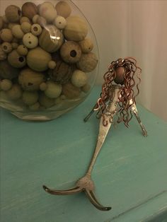 a pair of scissors sitting on top of a table next to a bowl filled with nuts