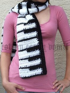 a woman wearing a black and white crocheted scarf
