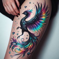 a woman's thigh with an artistic tattoo design on it and a colorful bird