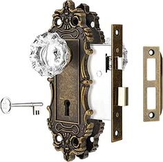 an ornate door handle with a glass knob and keyhole on the front of it