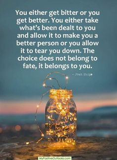 a jar filled with lights sitting on top of a wooden table