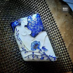 a blue and white vase sitting on top of a metal mesh tablecloth covered chair