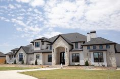 a large house with lots of windows in the front yard