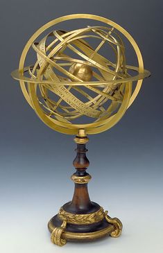 an antique brass and wood model of the solar system