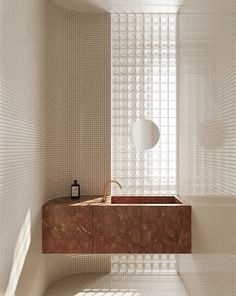 a bathroom with a sink and mirror next to a wall made out of white circles