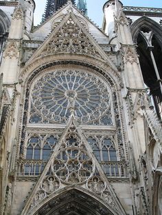 an old cathedral with ornate architecture and stonework on the front door, looking up