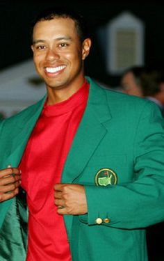 a man in a green jacket and red shirt