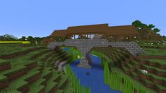 a bridge over a small river in the middle of a field