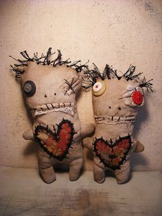 two stuffed animals with hearts on their backs