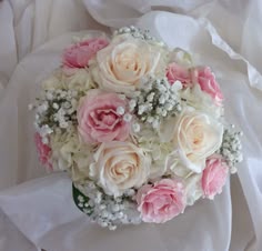 a bridal bouquet with pink and white flowers on it's wrapper,