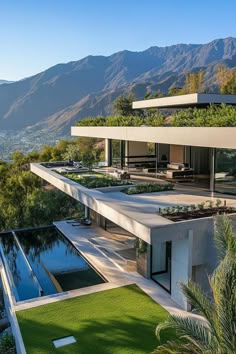 the house is surrounded by grass and mountains