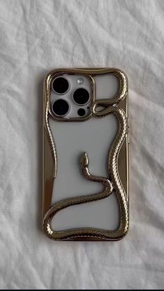 a cell phone case with a snake on the front and back sides, sitting on a white sheet