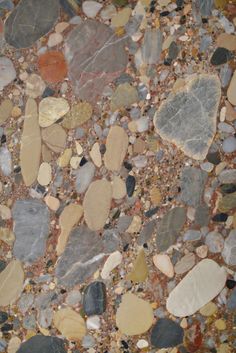 the floor is covered with various colored rocks