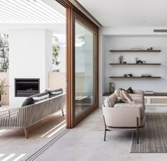 a living room filled with furniture and a fire place next to a wall mounted tv