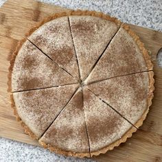 a pie sitting on top of a wooden cutting board