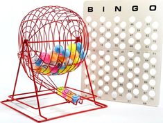 a colorful toy in a metal cage next to a calendar on a white background with the word bingo written below it