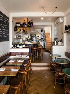 an empty restaurant with wooden tables and chairs