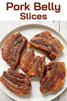 pork belly slices on a white plate with the words pork belly slices overlayed