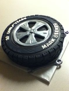 there is a cake made to look like a tire on top of a piece of paper