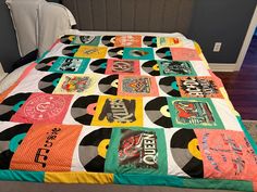 a bed with a colorful quilt on top of it