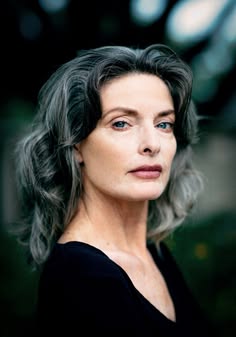 a woman with grey hair and blue eyes